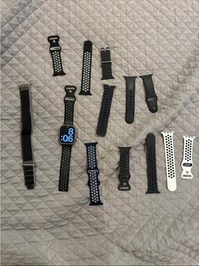 Apple Smartwatch with Multiple Black, Blue, and White Sport Bands